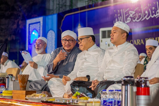 A group of men sitting next to each other