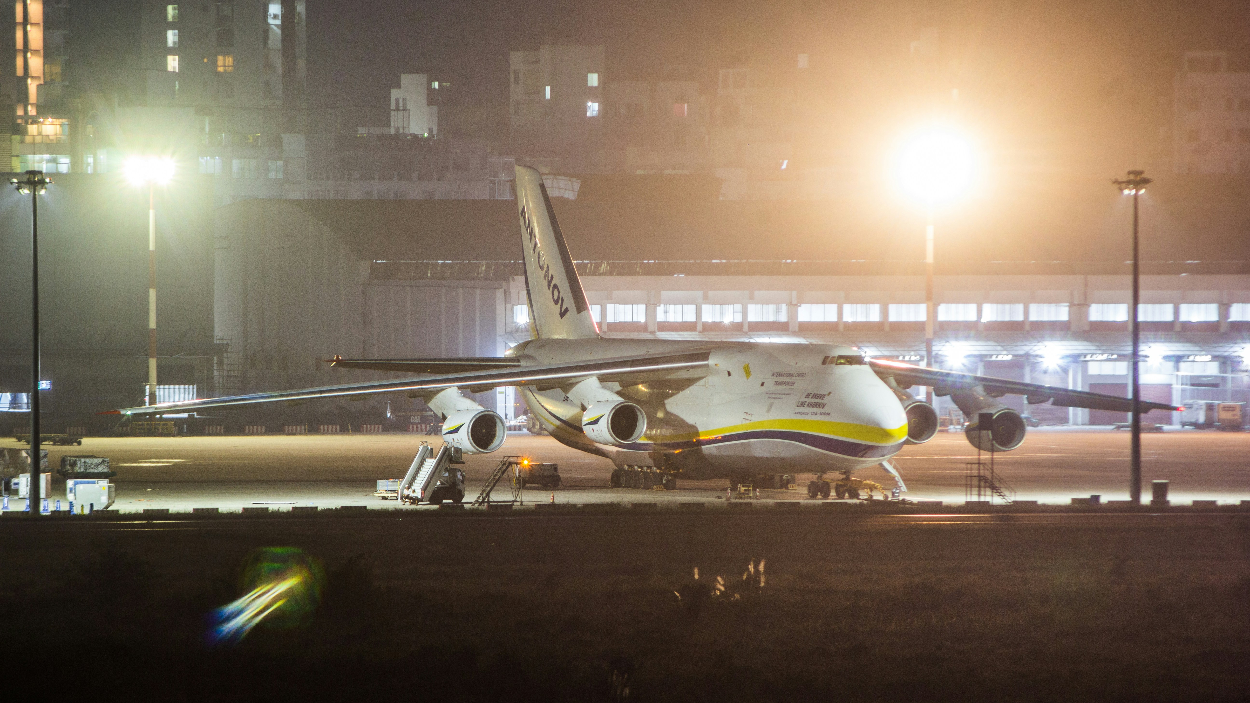 An airplane is parked on the runway at night, Antonov An124 in Dhaka airport resting.