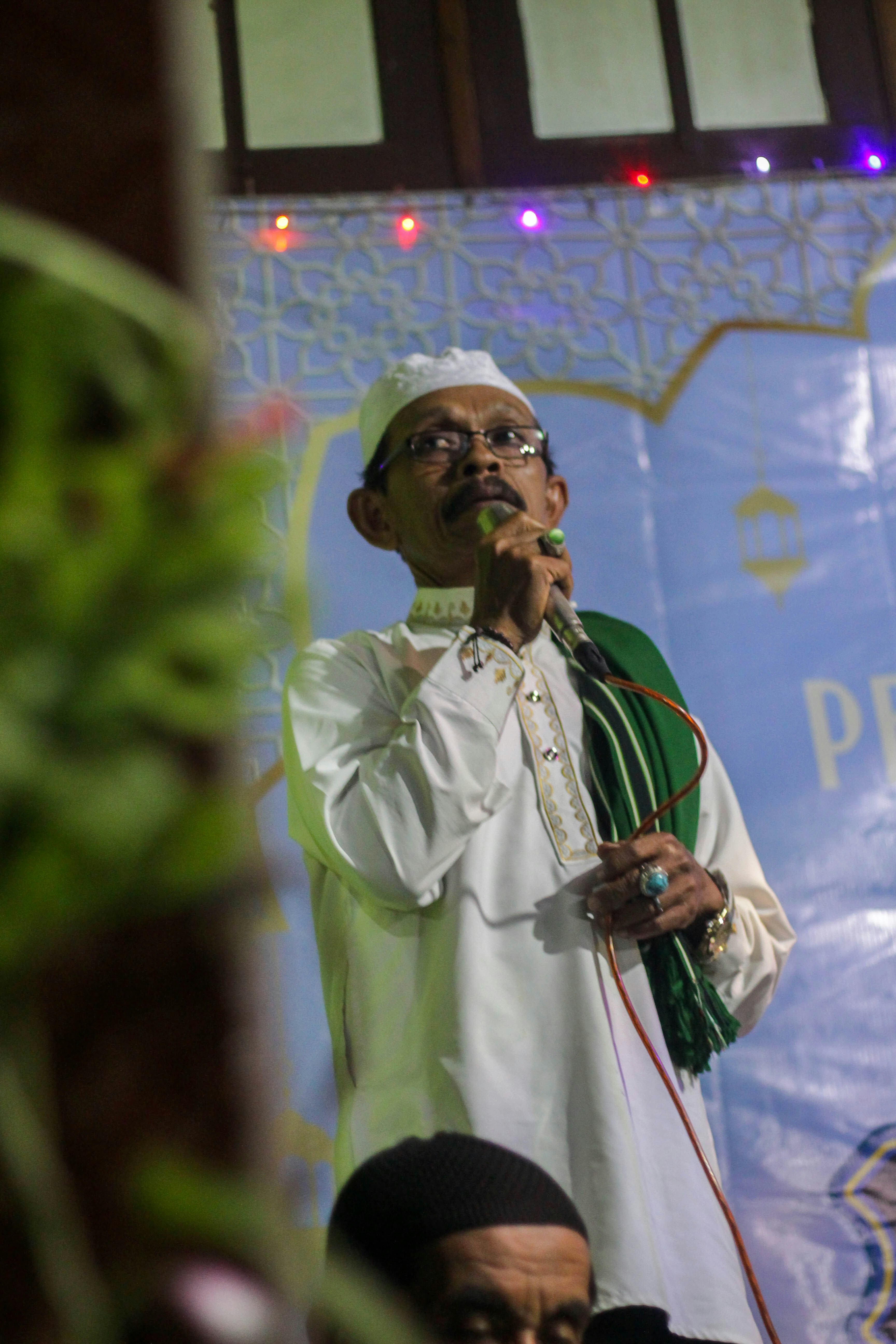 A man standing on a stage holding a microphone