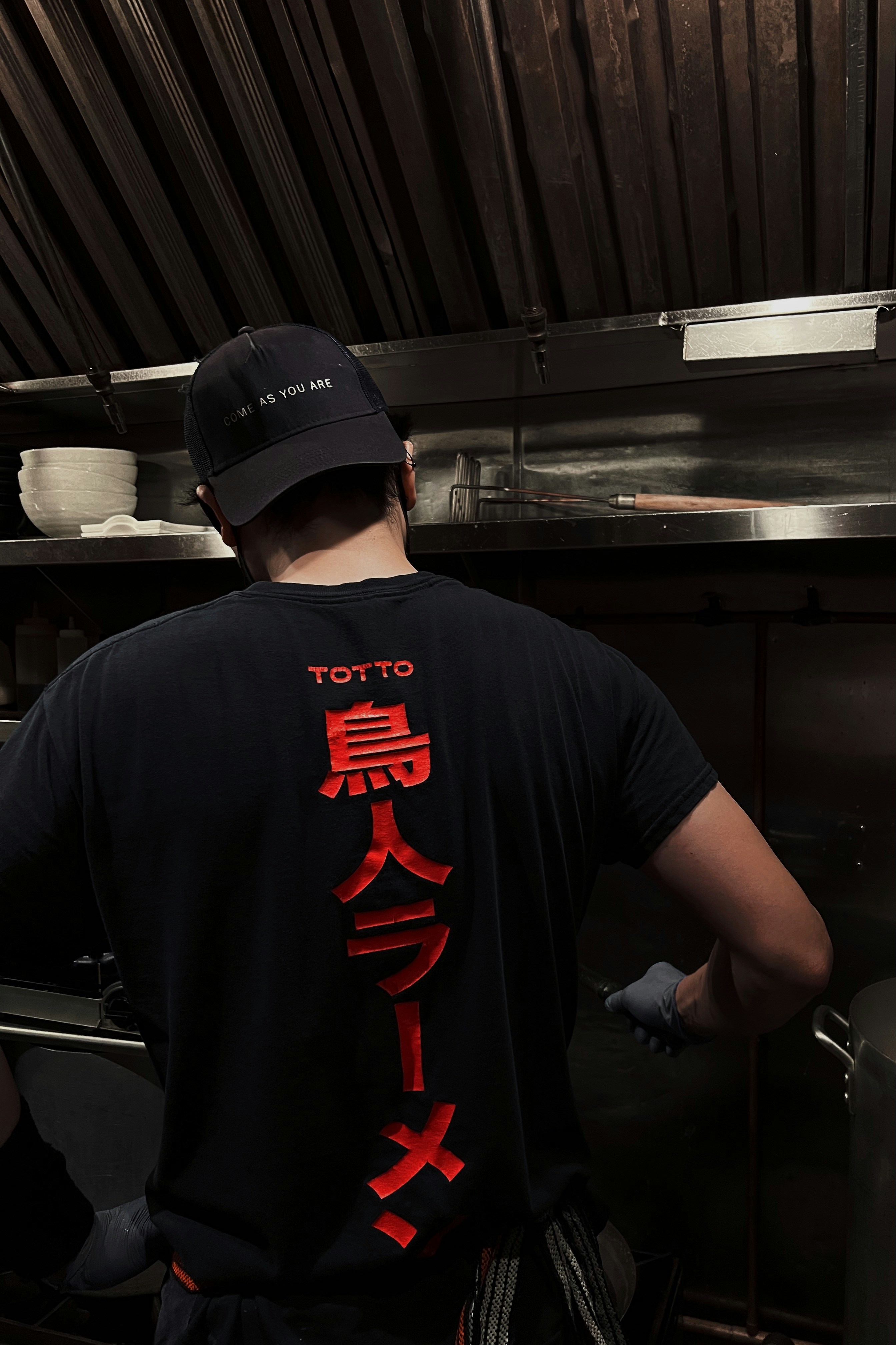 A man standing in a kitchen preparing food