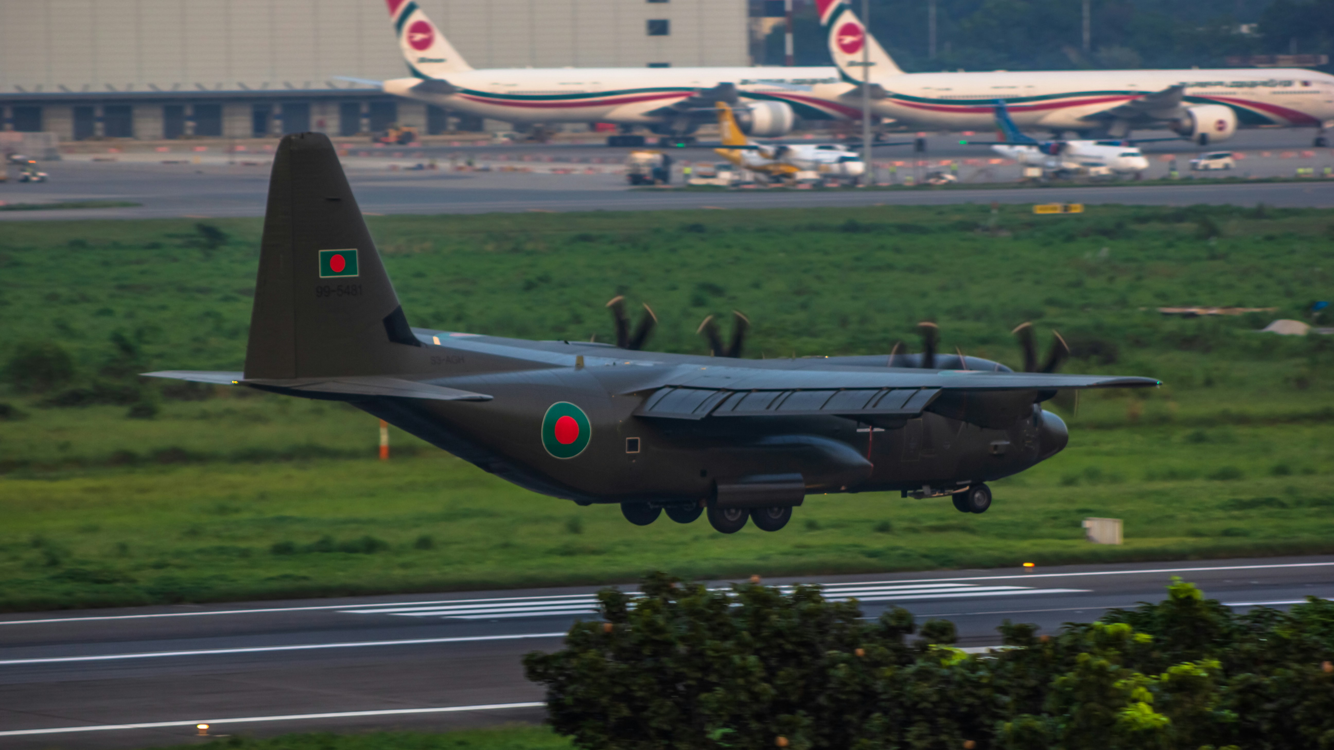 A military jet taking off from an airport runway