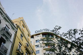 A tall building with a sign that says only you