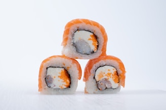 Four pieces of sushi stacked on top of each other