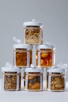 A stack of jars filled with different types of food