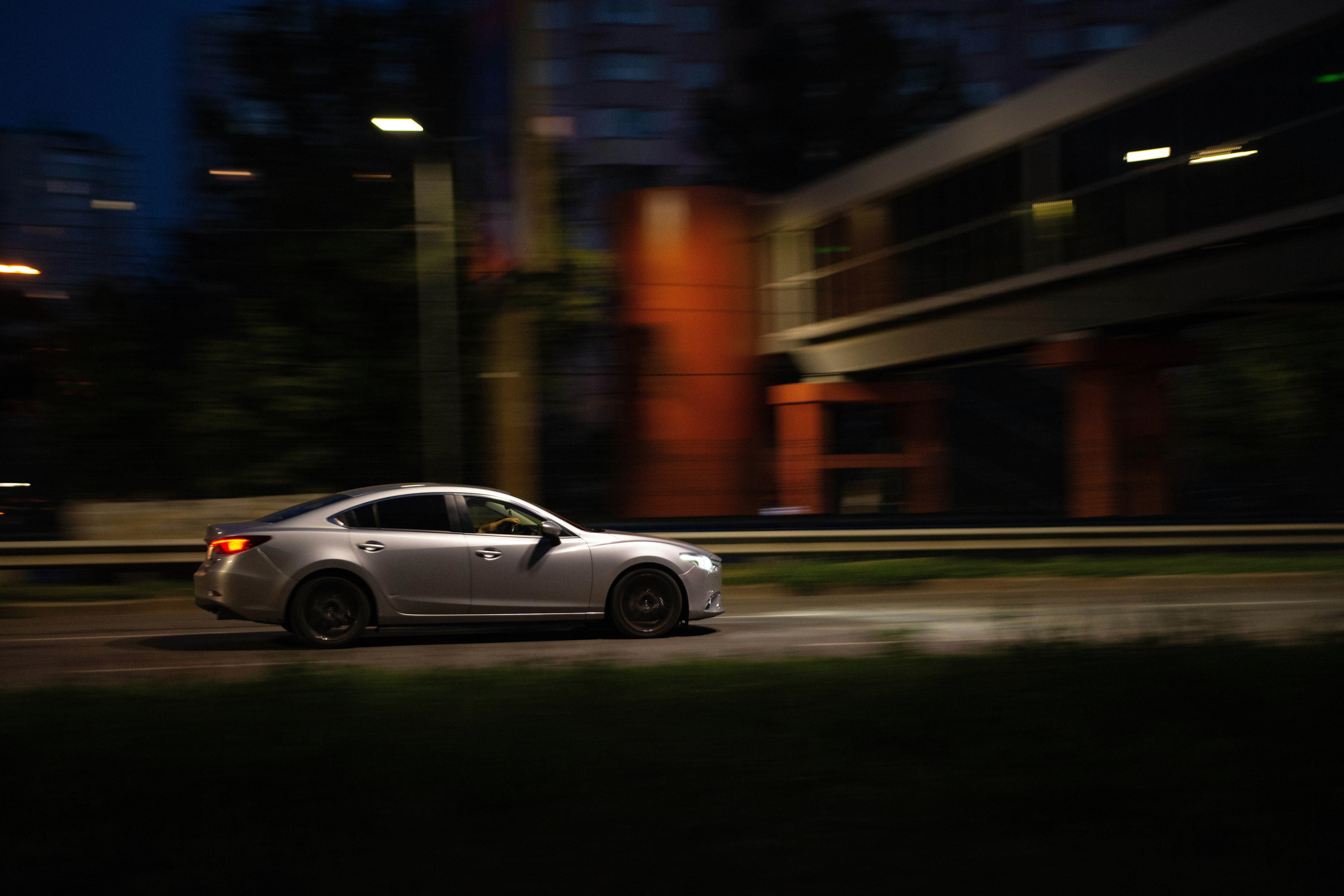 A car driving down a street at night