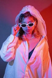 A woman in a white jacket and sunglasses