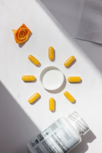 A bottle of pills and a rose on a table