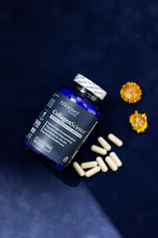 A close up of a bottle of pills next to flowers