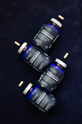 Three bottles of vitamins sitting next to each other