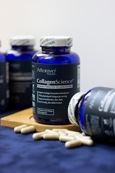 A bottle of collagen's science next to some pills