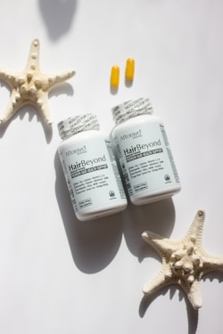 A couple of bottles of pills sitting next to a starfish