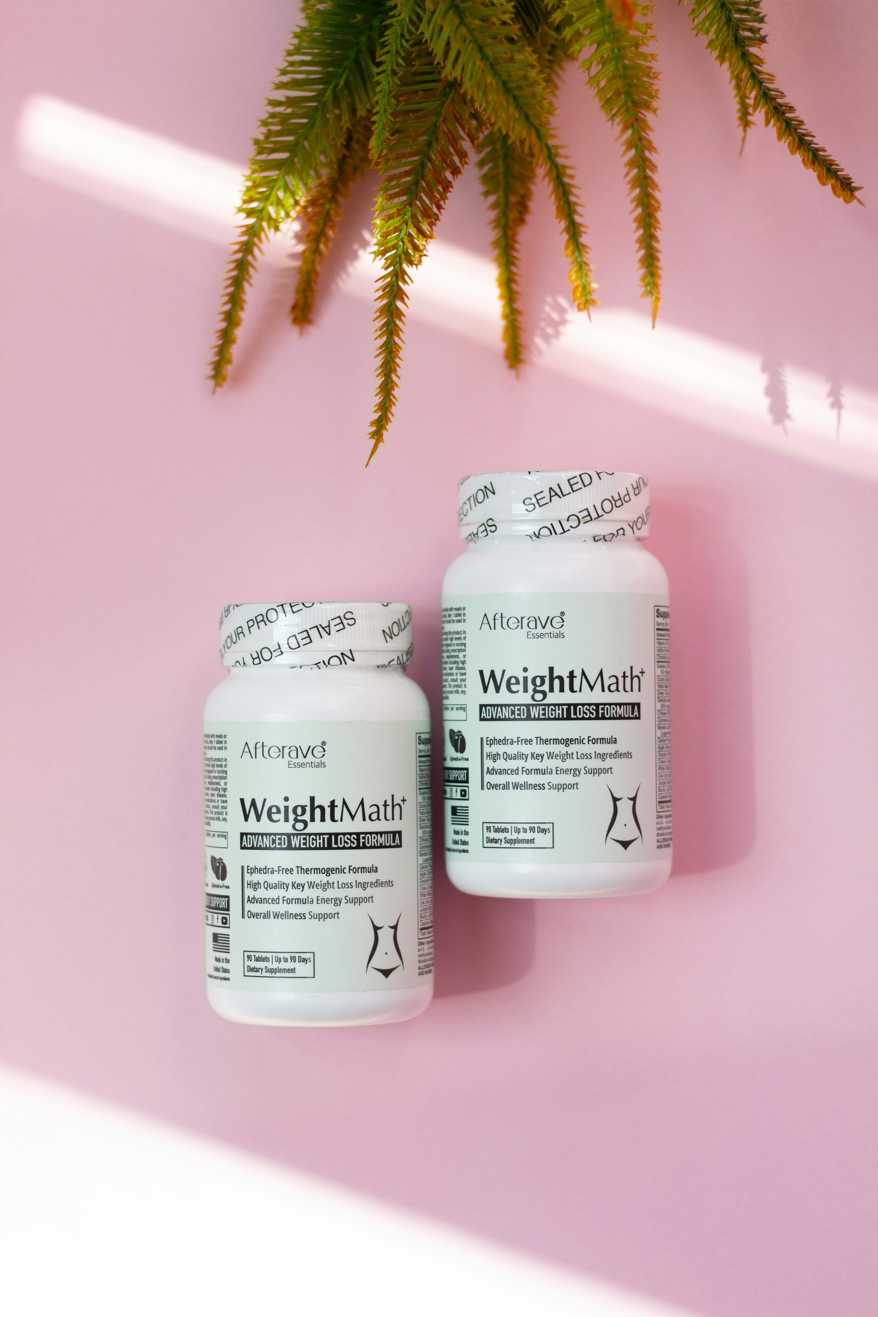 Two bottles of weight matters on a pink background