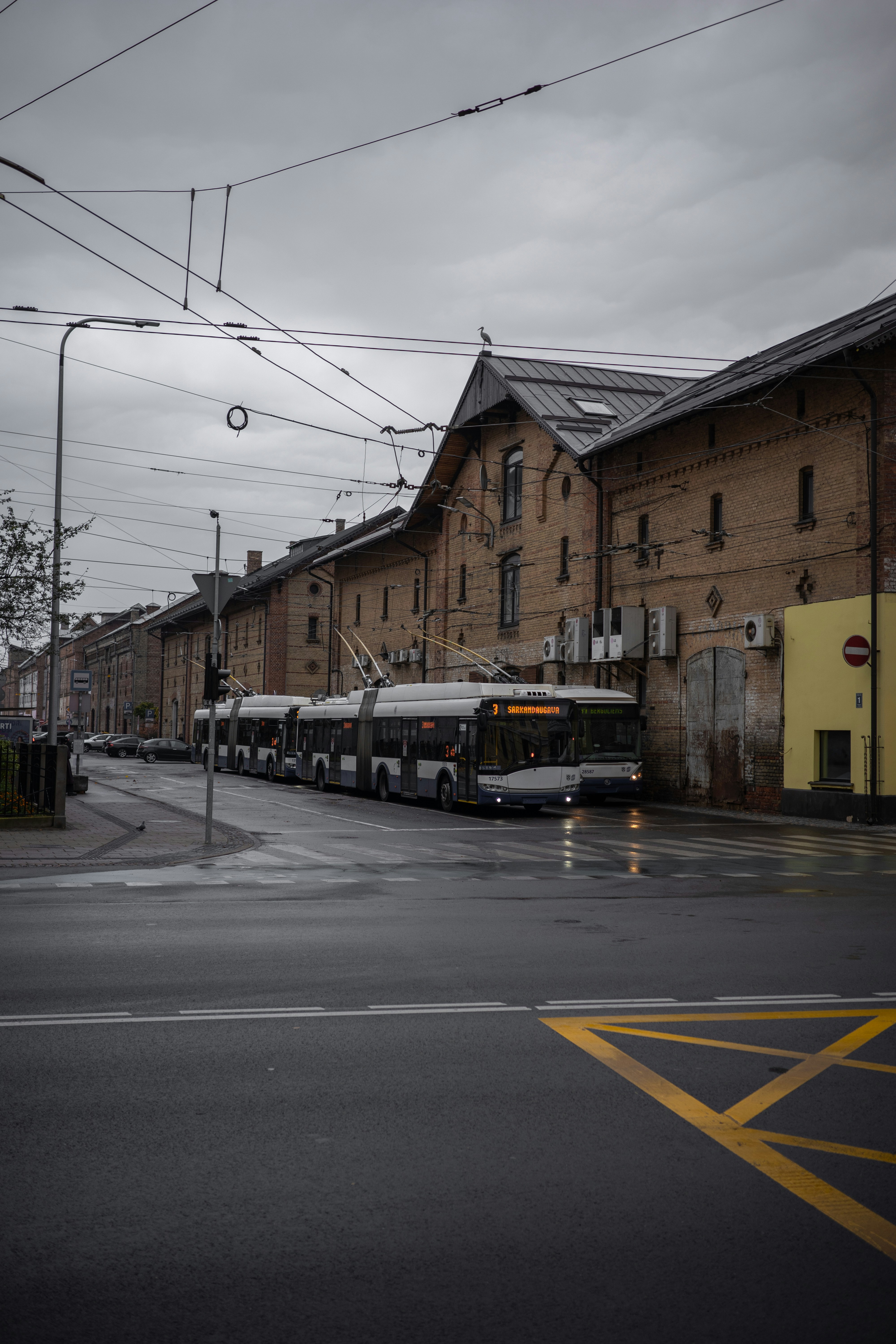 A city street with buses parked on the side of it