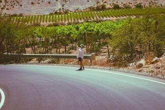 A man riding a skateboard down a curvy road
