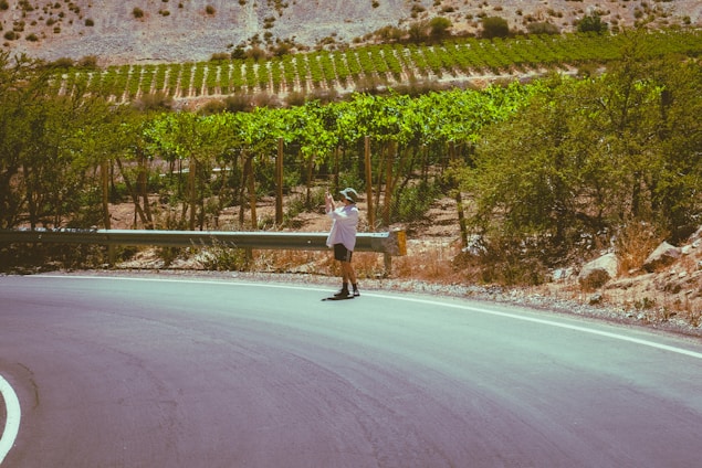 A man riding a skateboard down a curvy road