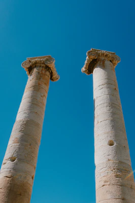 Two tall white pillars against a blue sky