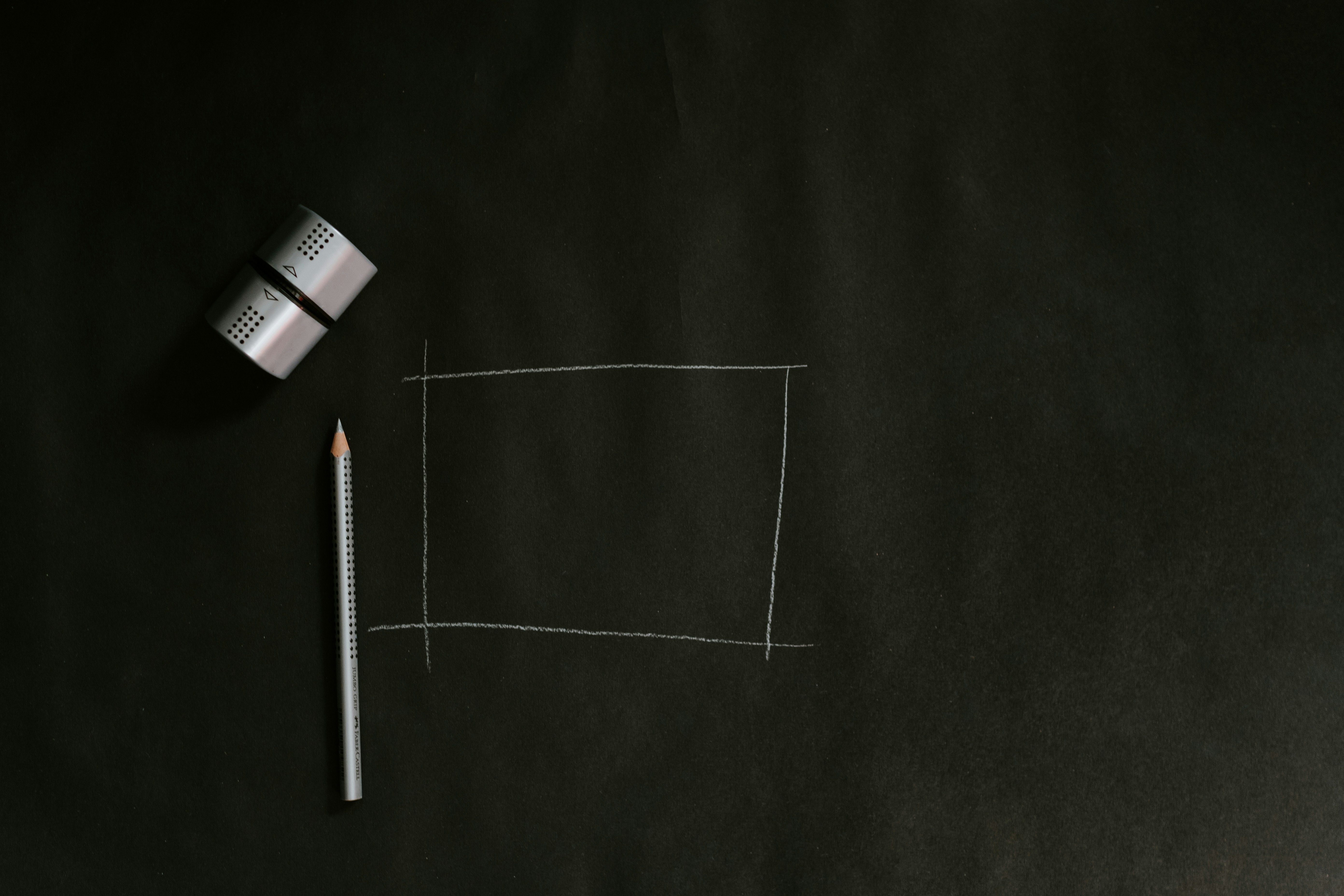 A blackboard with a pencil and eraser on it