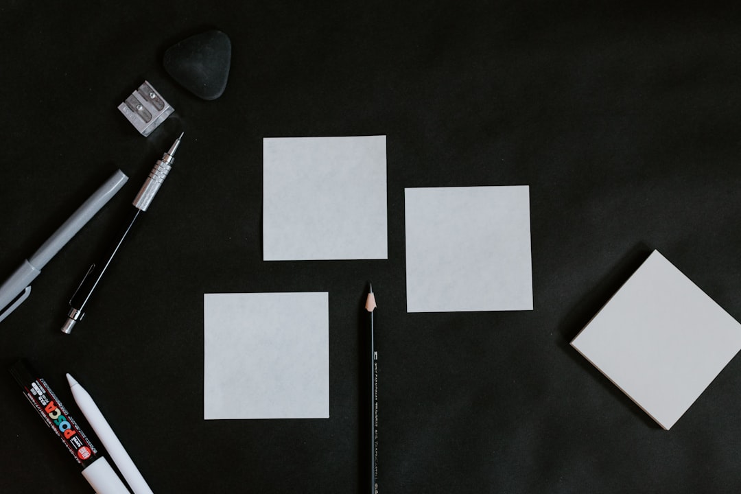 A black table topped with white cards and a pencil,