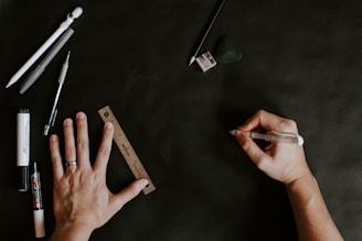 A person's hand holding a pen over a piece of paper