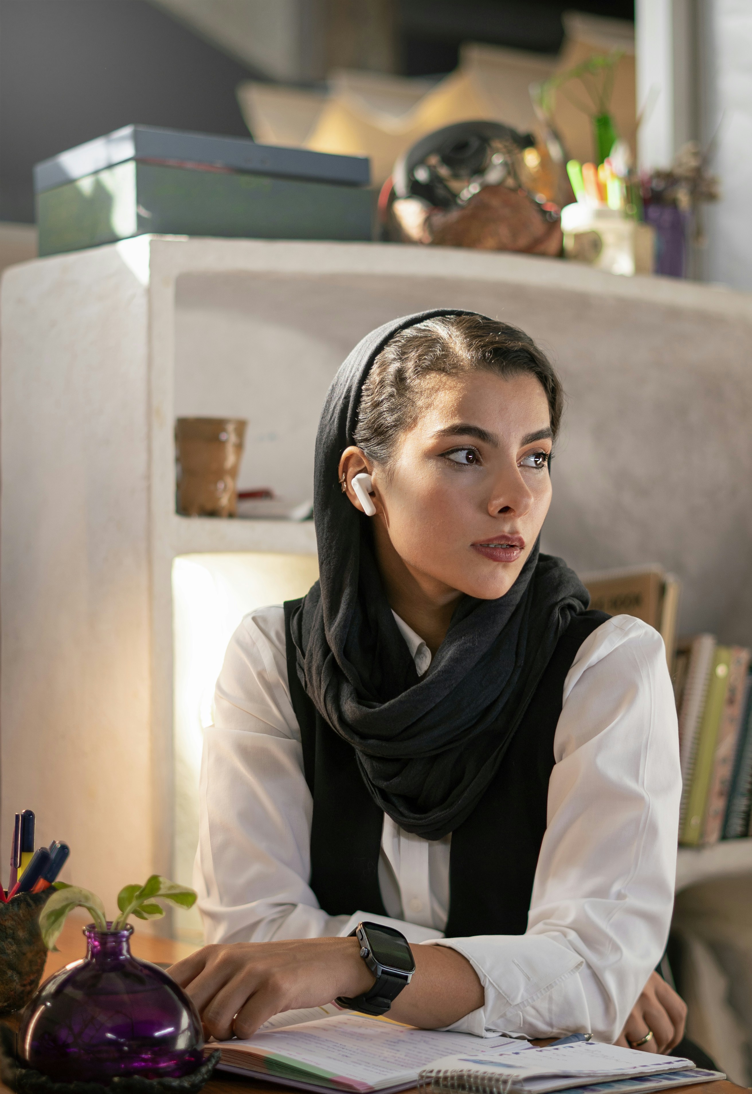A woman sitting at a table with a book