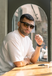 A man sitting at a table with a cell phone
