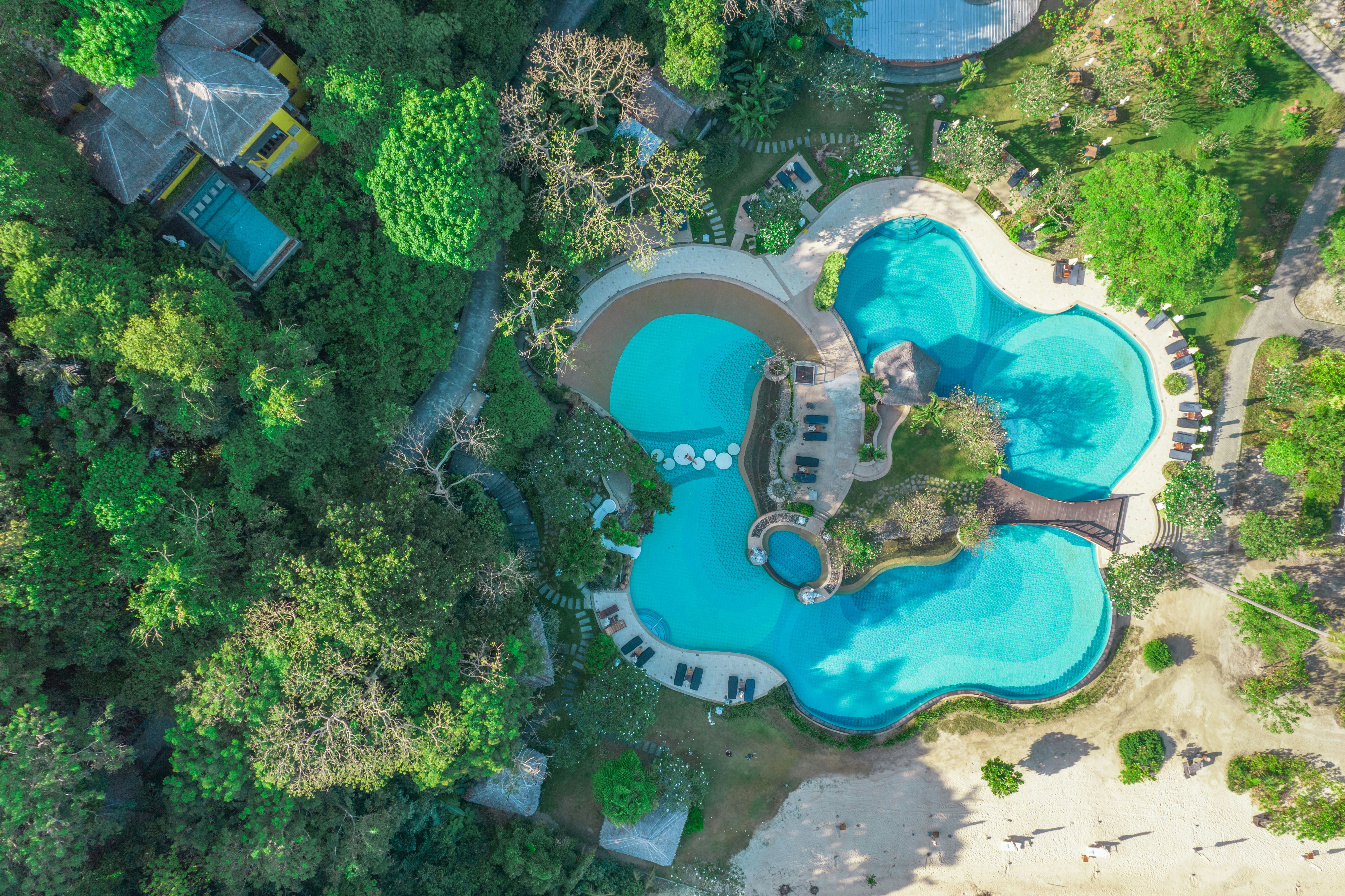 An aerial view of a resort surrounded by trees, 