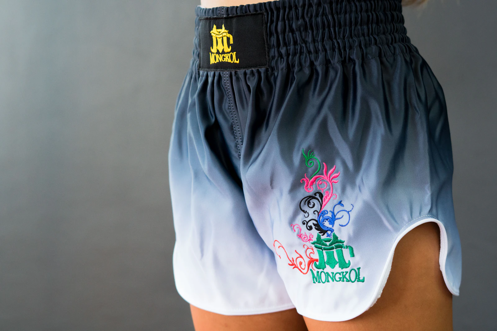 Close-up of Muay Thai shorts worn, showing waistband and embroidery detail