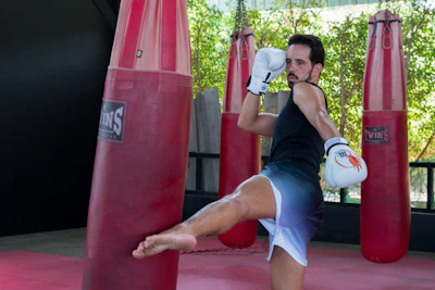 A man is kicking a kick in a boxing ring
