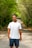 A man standing in the middle of a dirt road