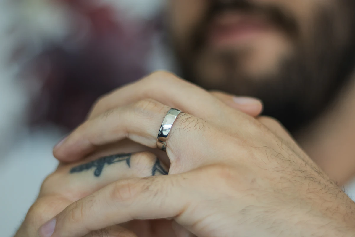 A close up of a person wearing a wedding ring
