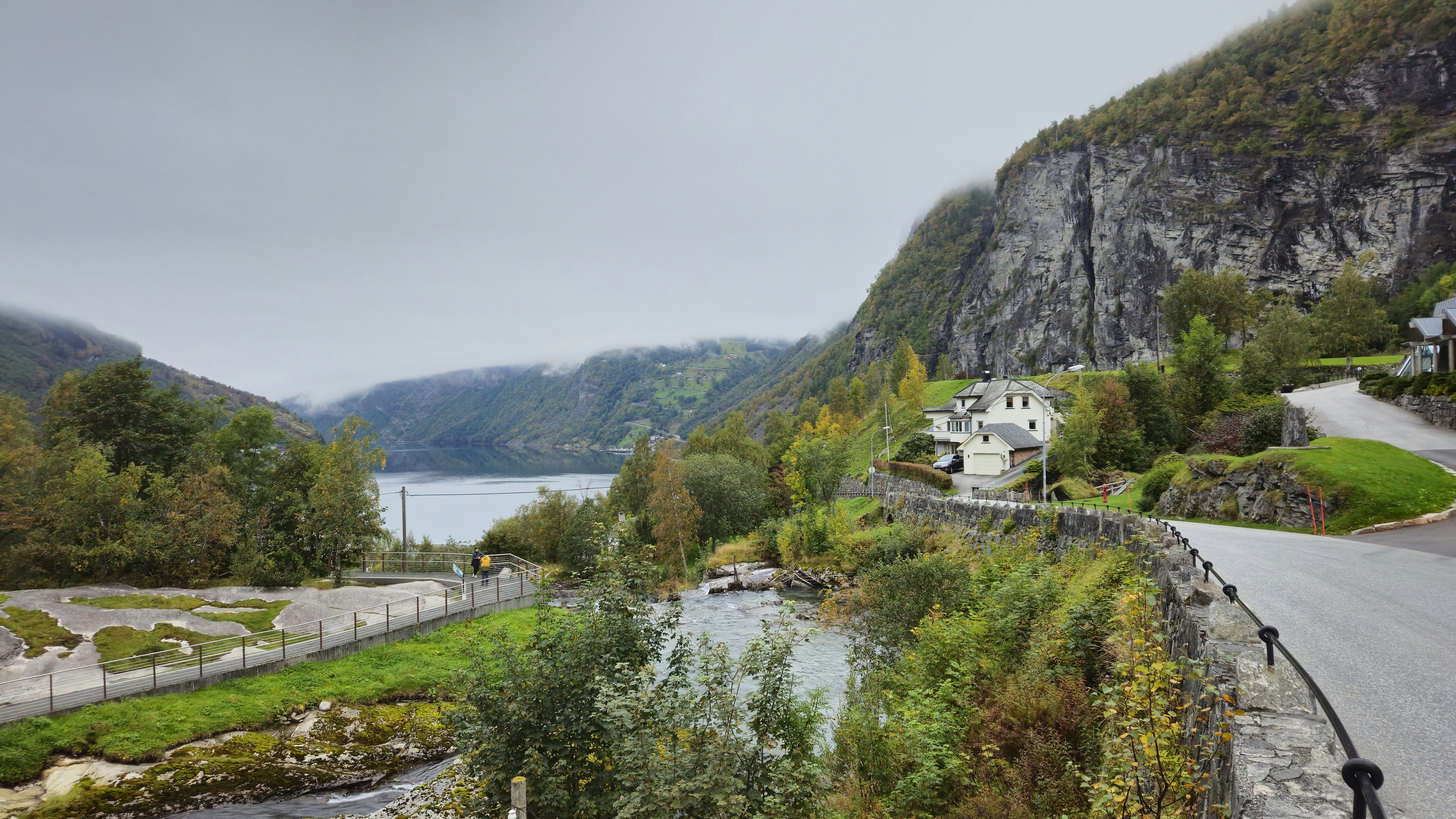 A scenic view of a mountain road and a body of water