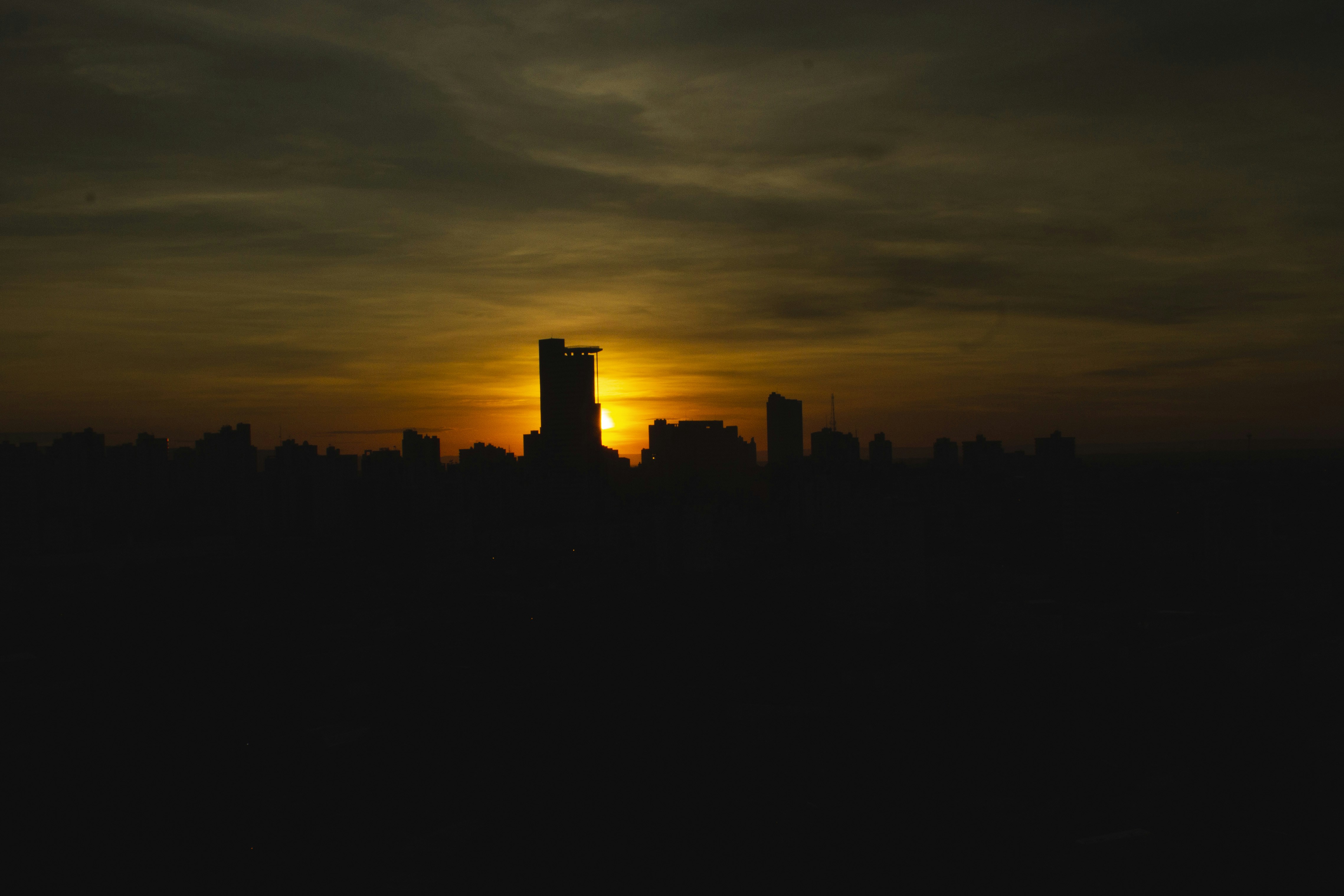 The sun is setting over a city skyline