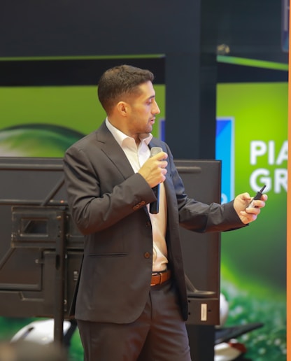 A man in a suit speaking into a microphone