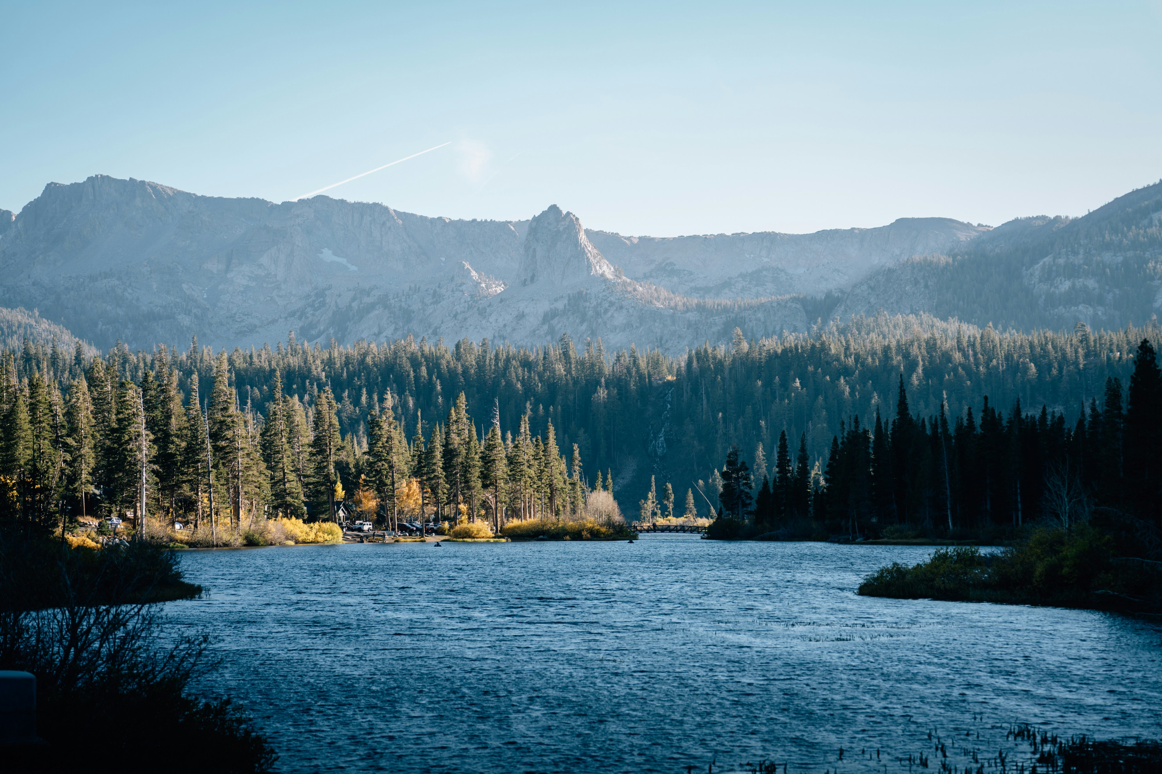 A lake surrounded by mountains and trees