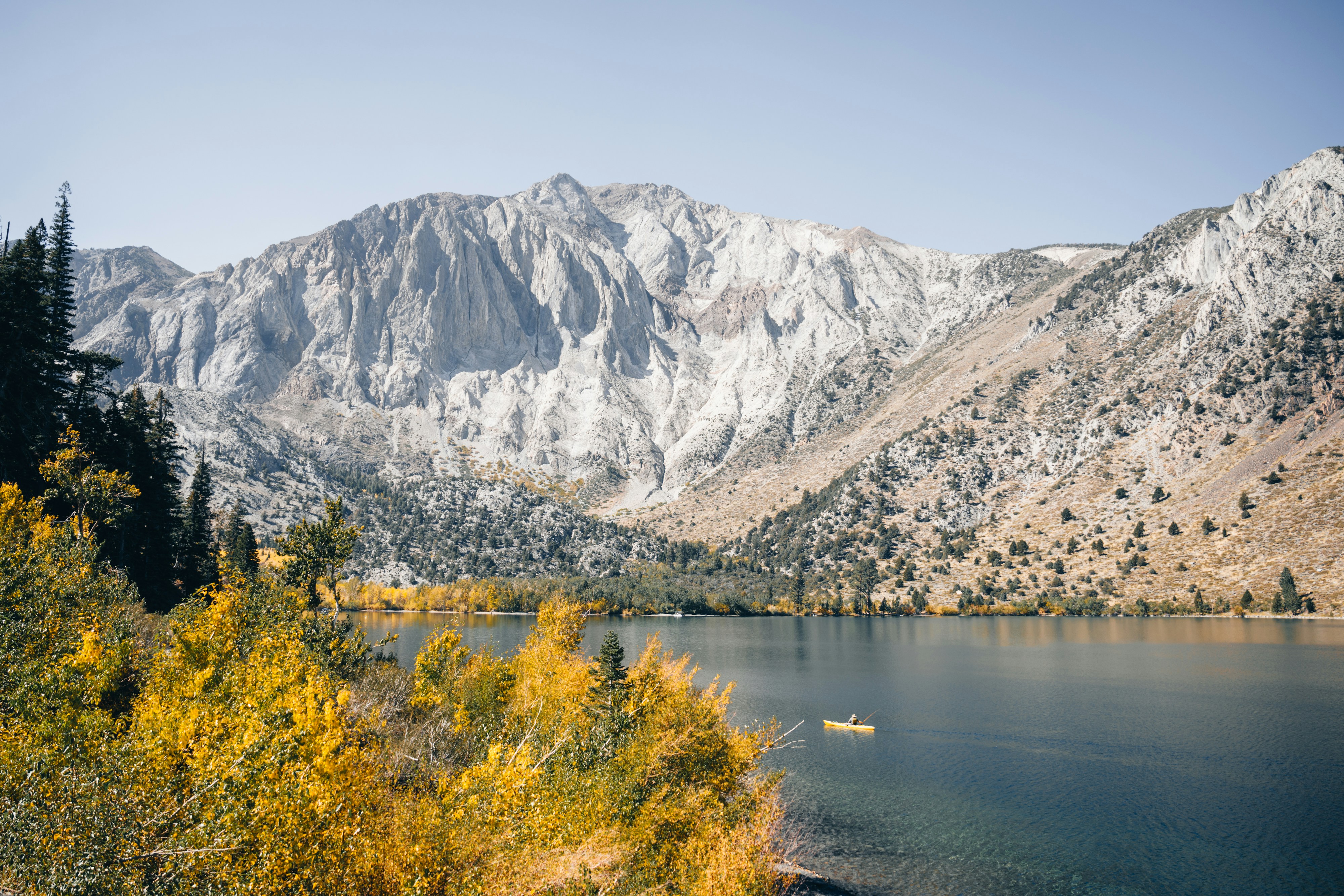A lake surrounded by mountains and trees
