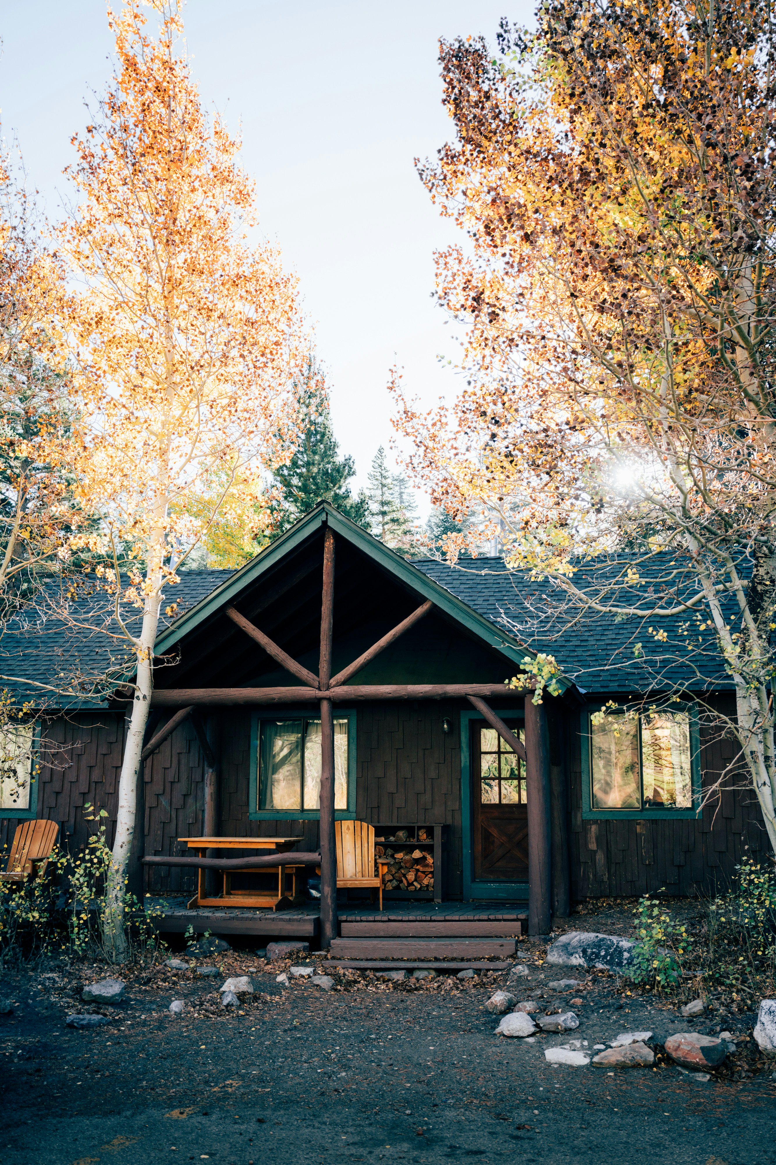 A cabin with a picnic table in front of it