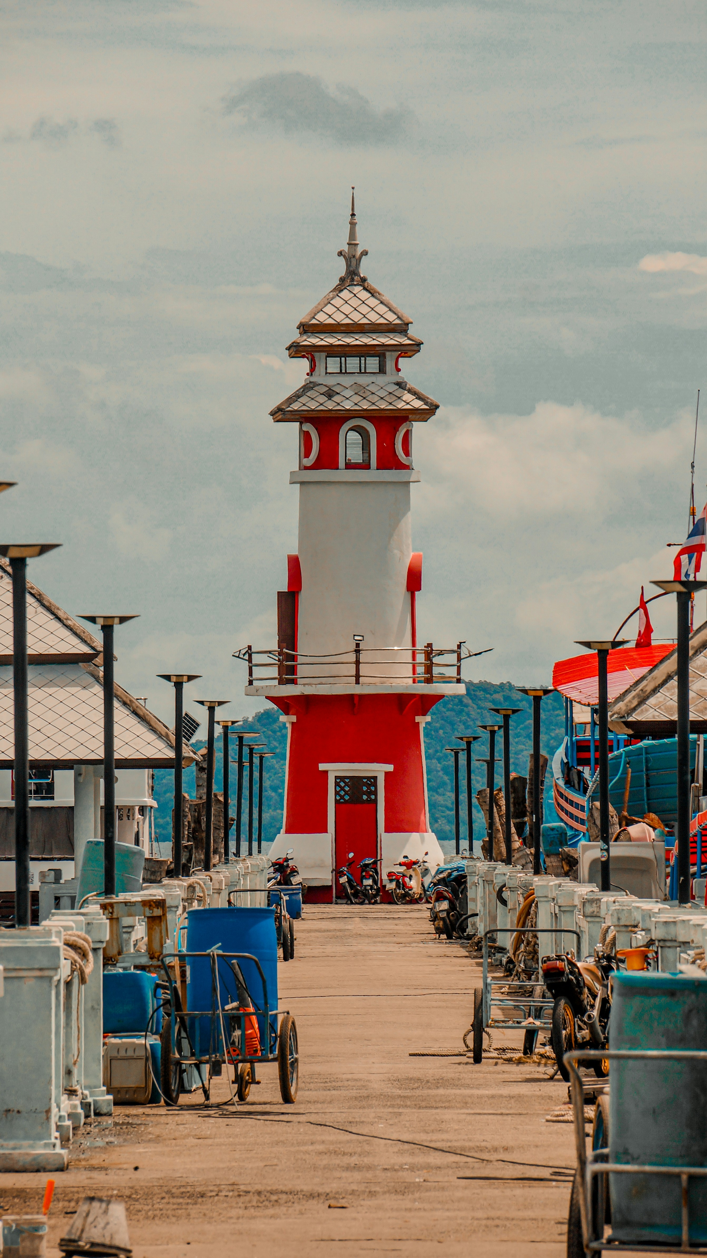 A red and white lighthouse sitting on top of a pier
