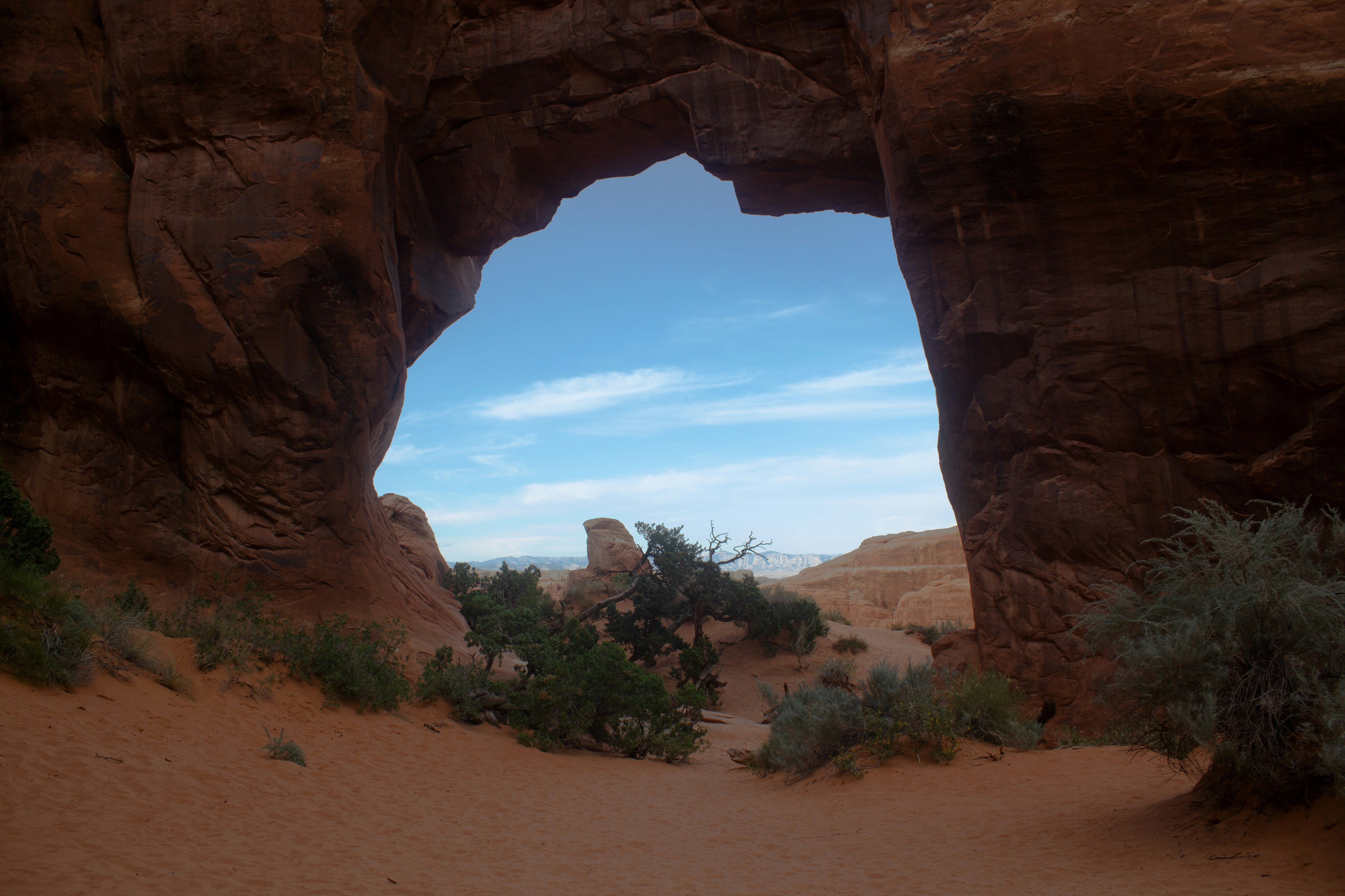 A large rock formation in the middle of a desert, 