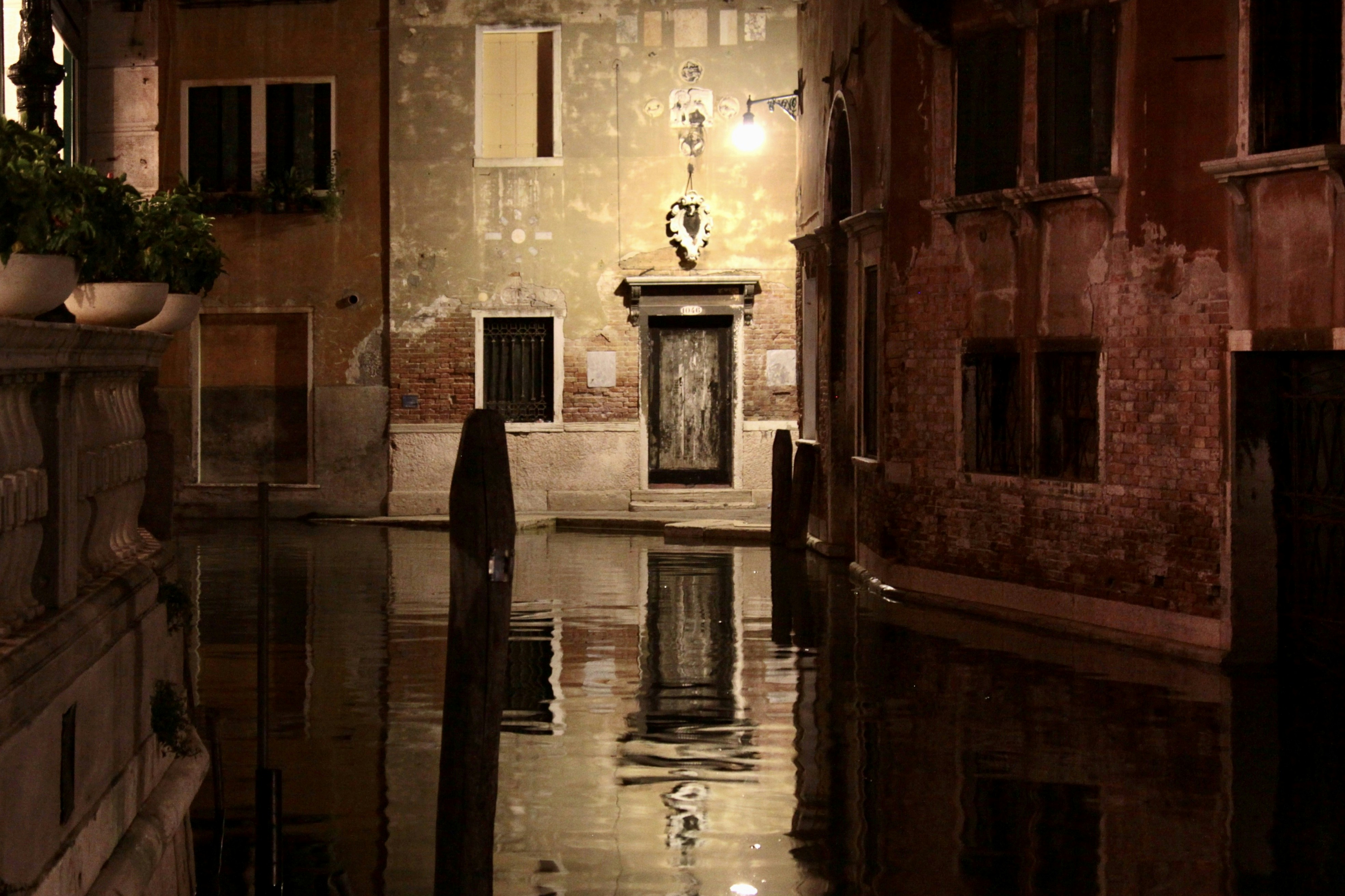 A narrow alley way with a clock on the wall