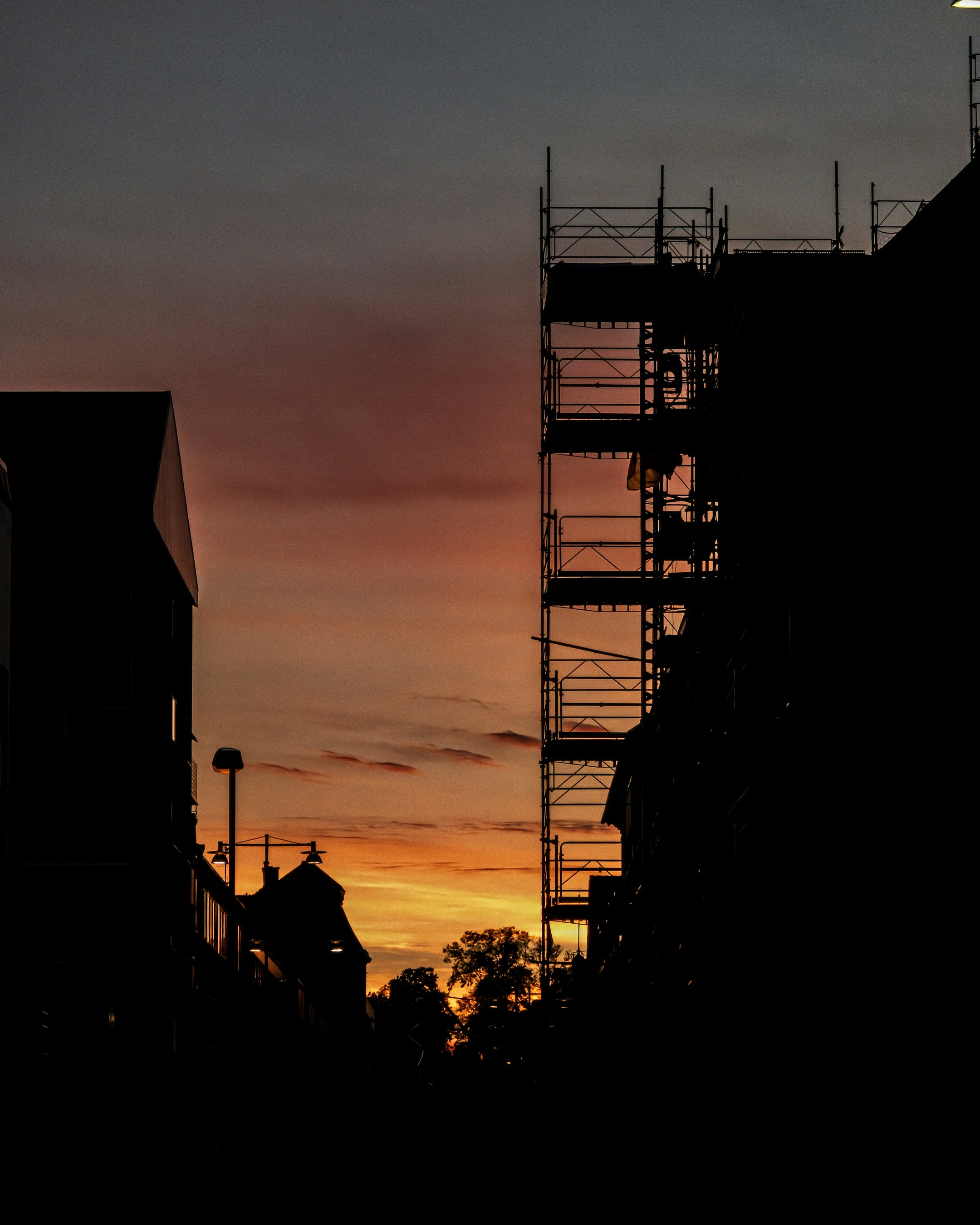 Building exterior with scaffolding system at golden hour