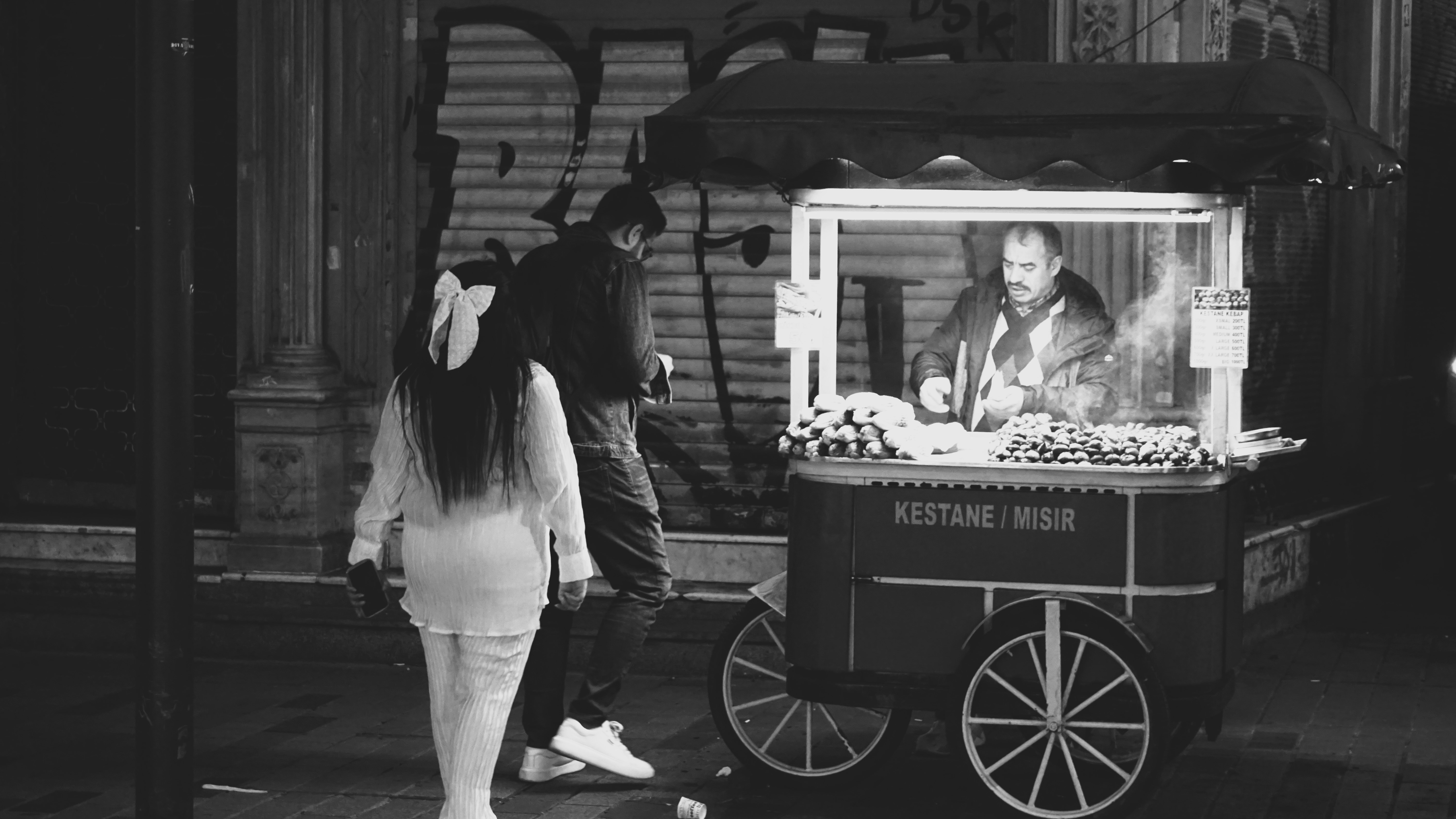 A black and white photo of a man and a woman standing in front of a