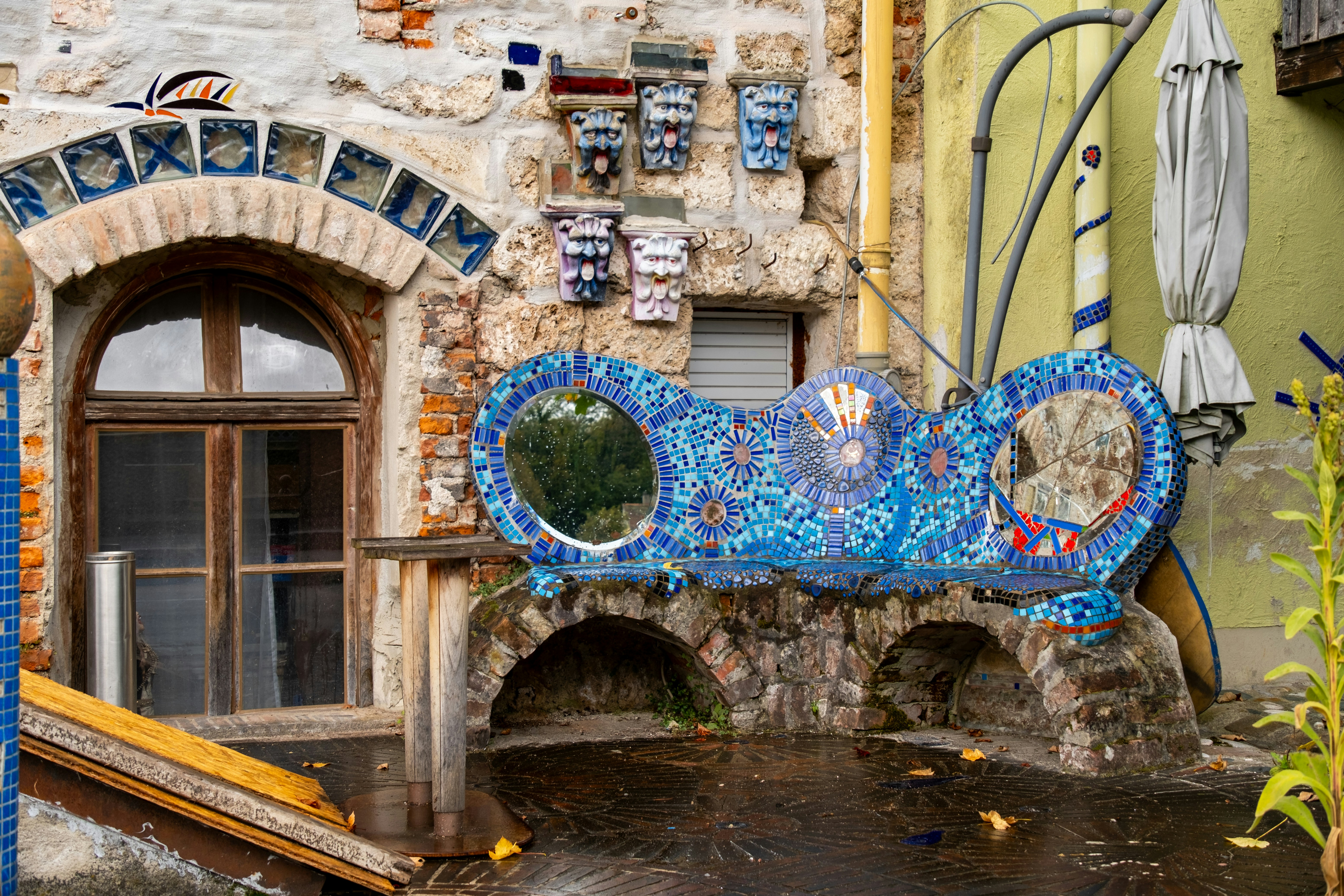 A blue bench sitting in front of a building