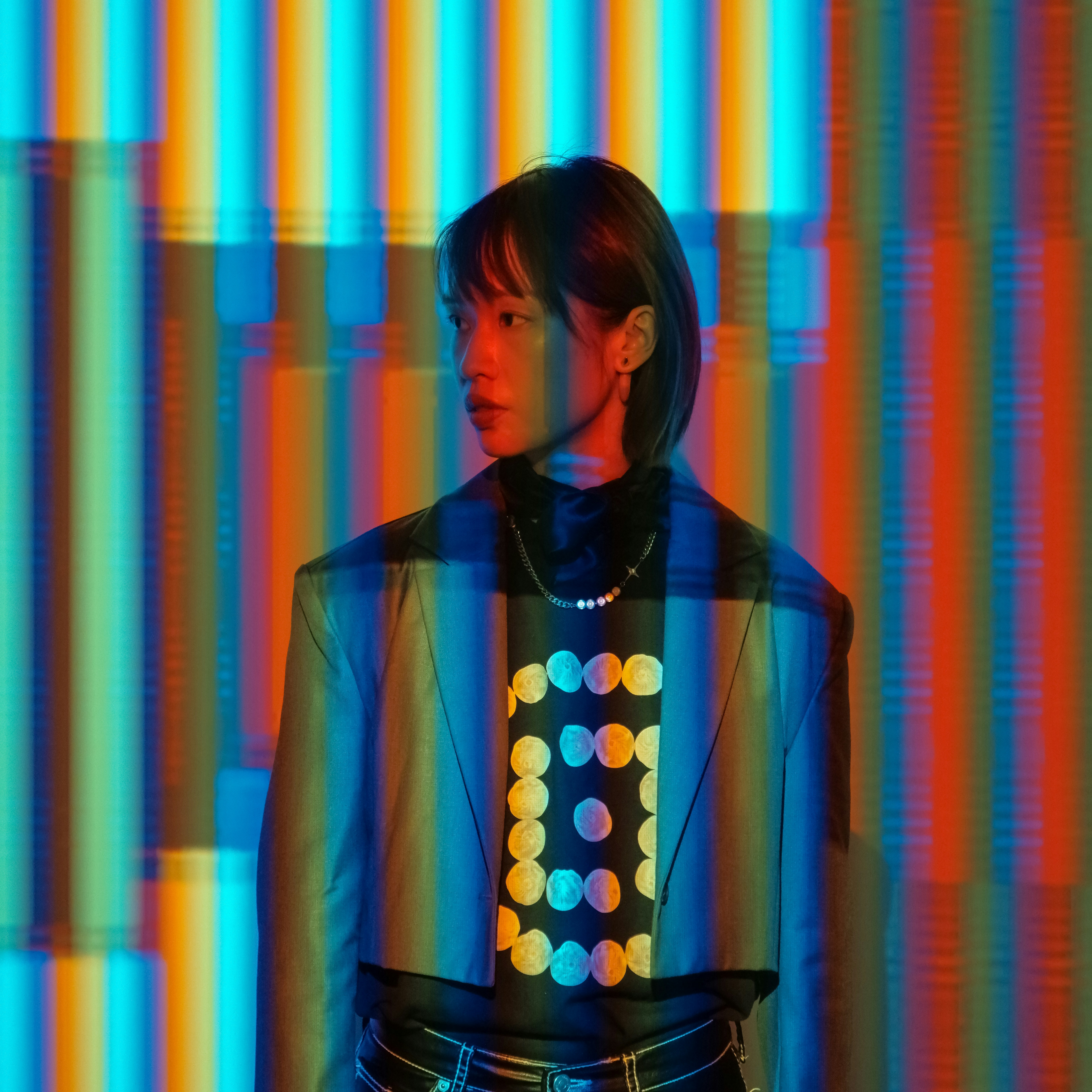 A man standing in front of a multicolored wall