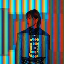 A man standing in front of a multicolored wall