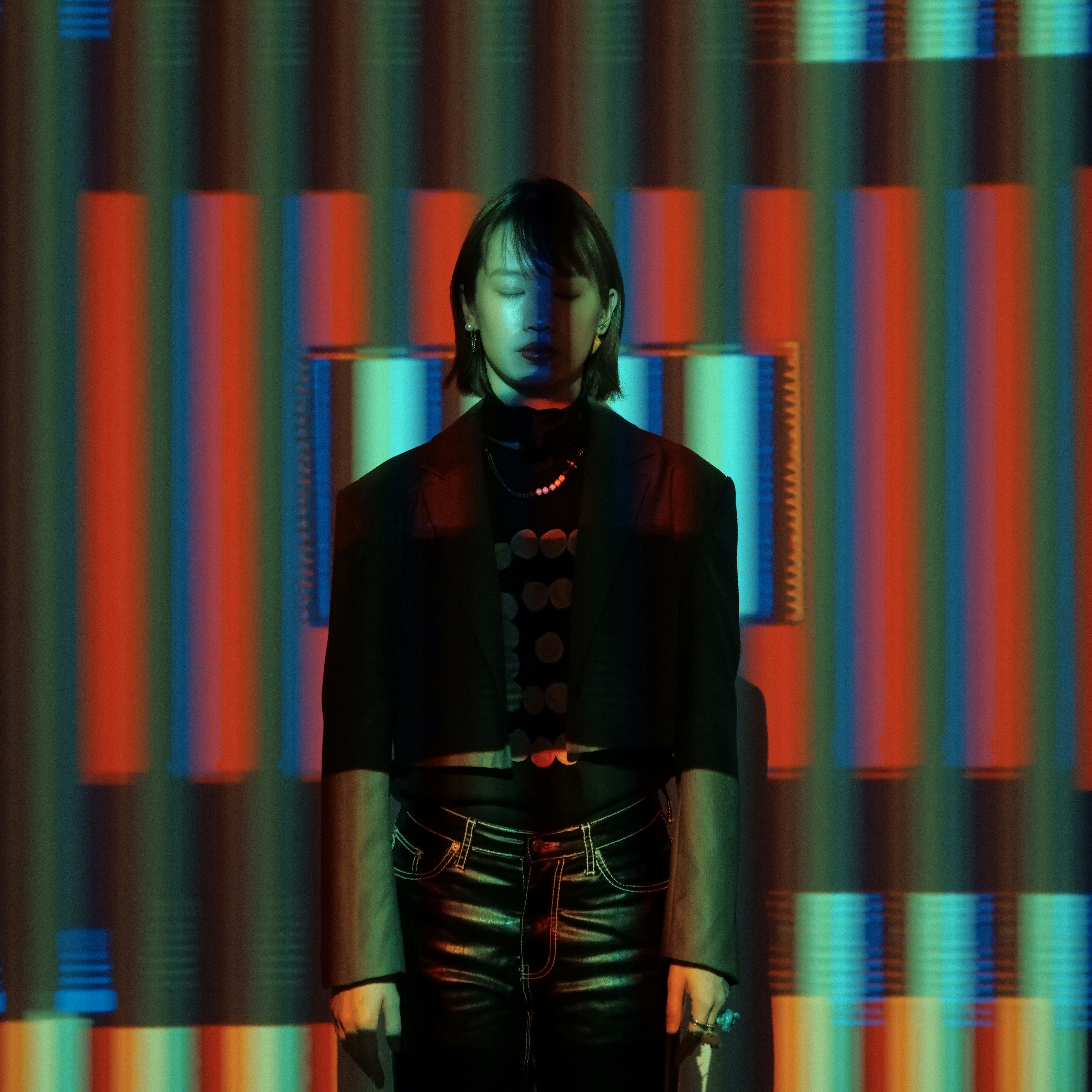 A man standing in front of a colorful background