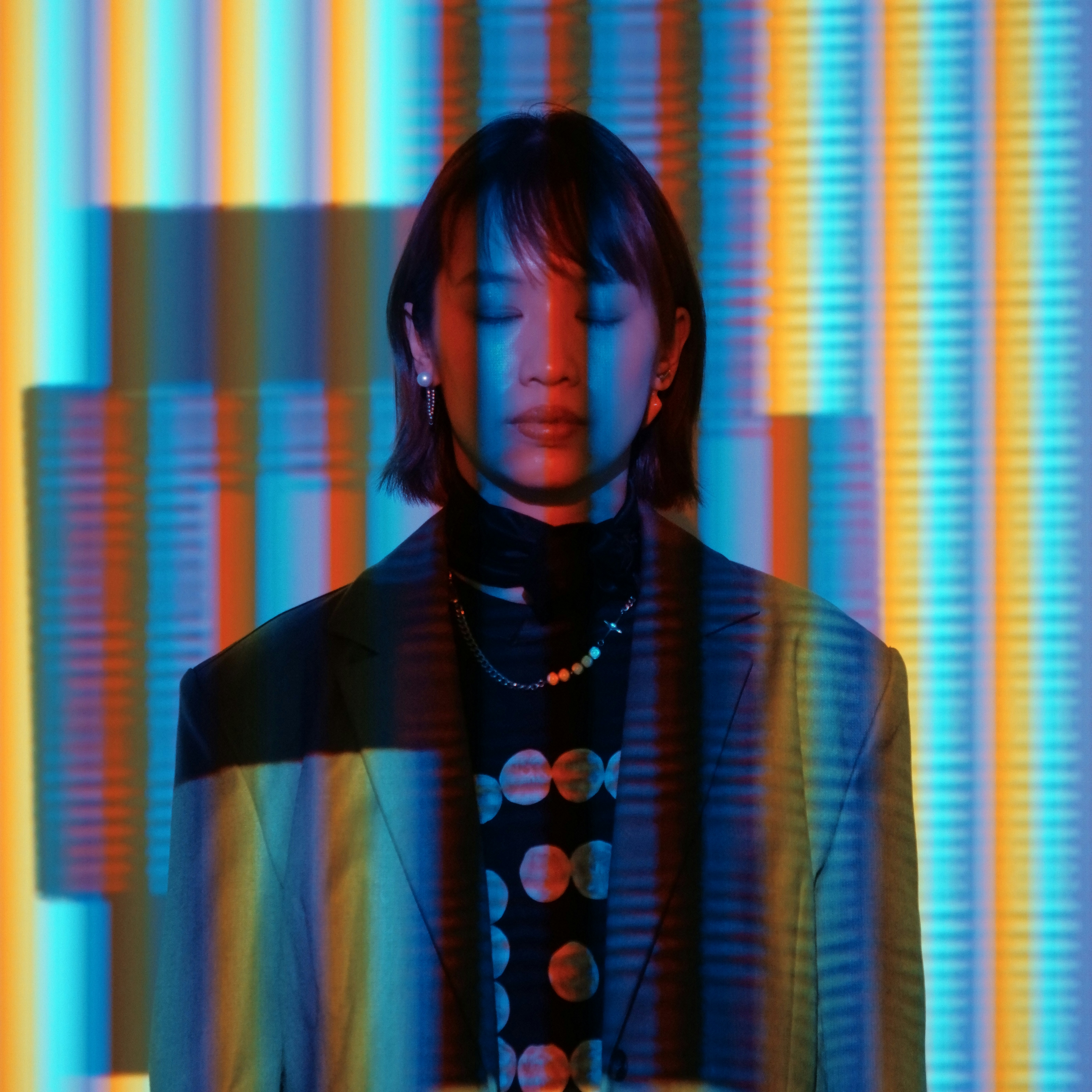 A woman standing in front of a colorful wall