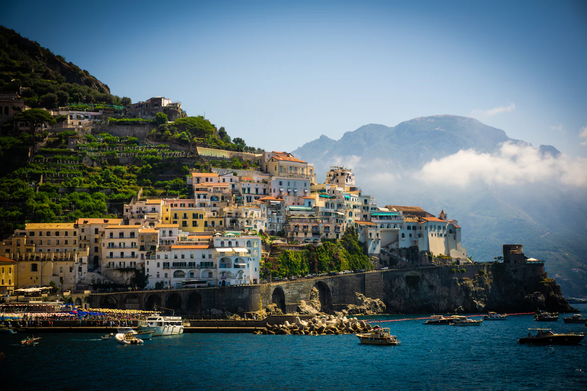Amalfi Coast cliffside town with colorful stacked buildings overlooking boats in the Mediterranean