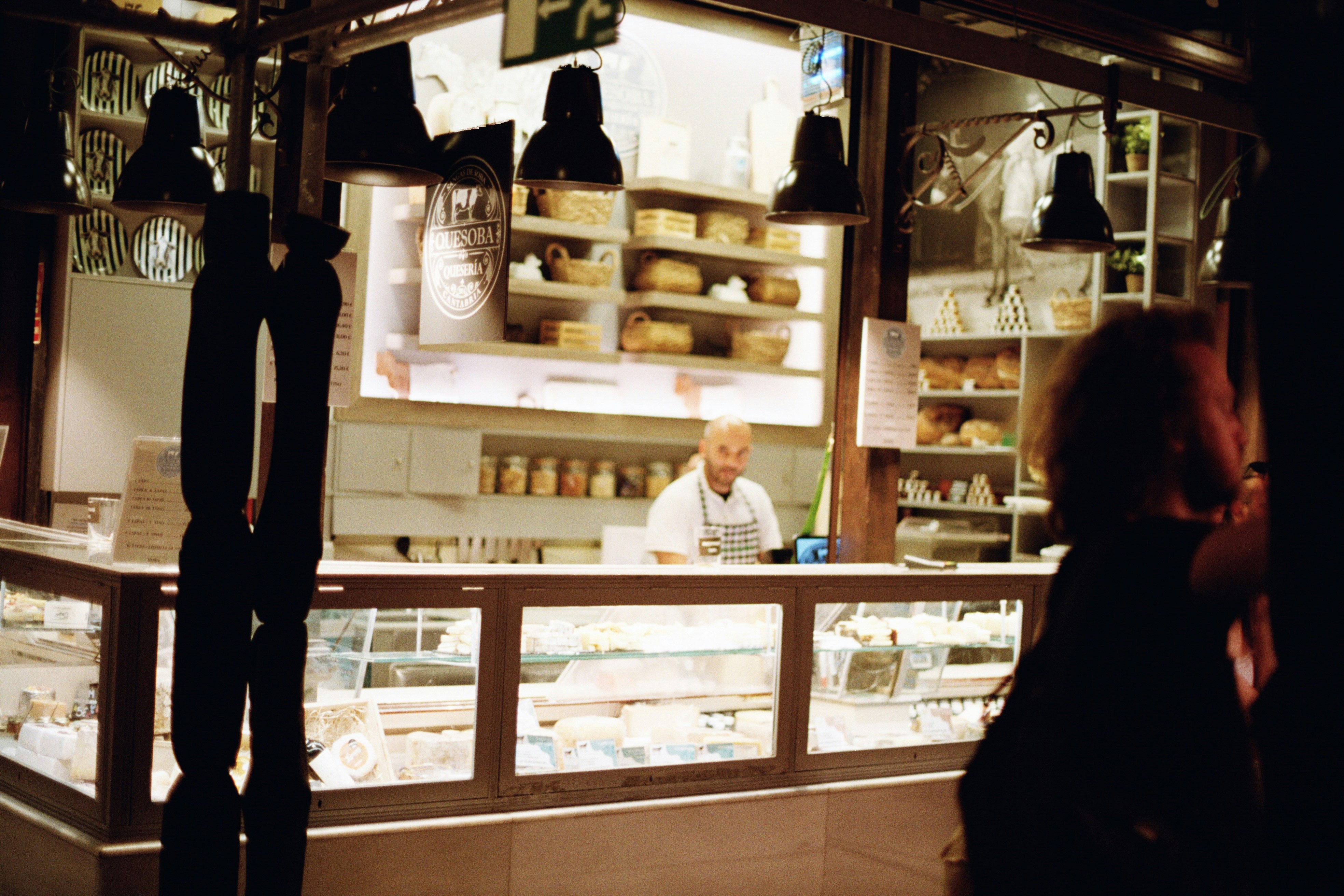 A man and a woman standing in front of a bakery