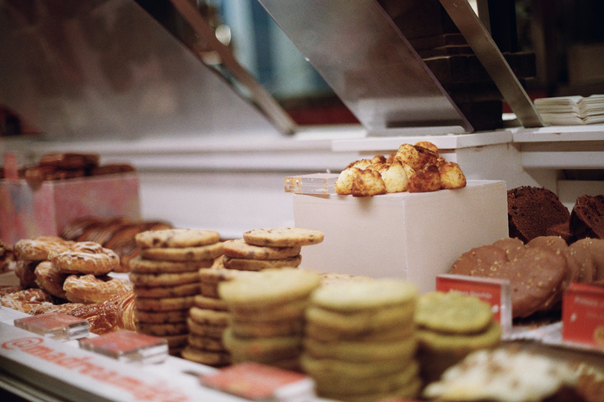 A display case filled with lots of different types of pastries