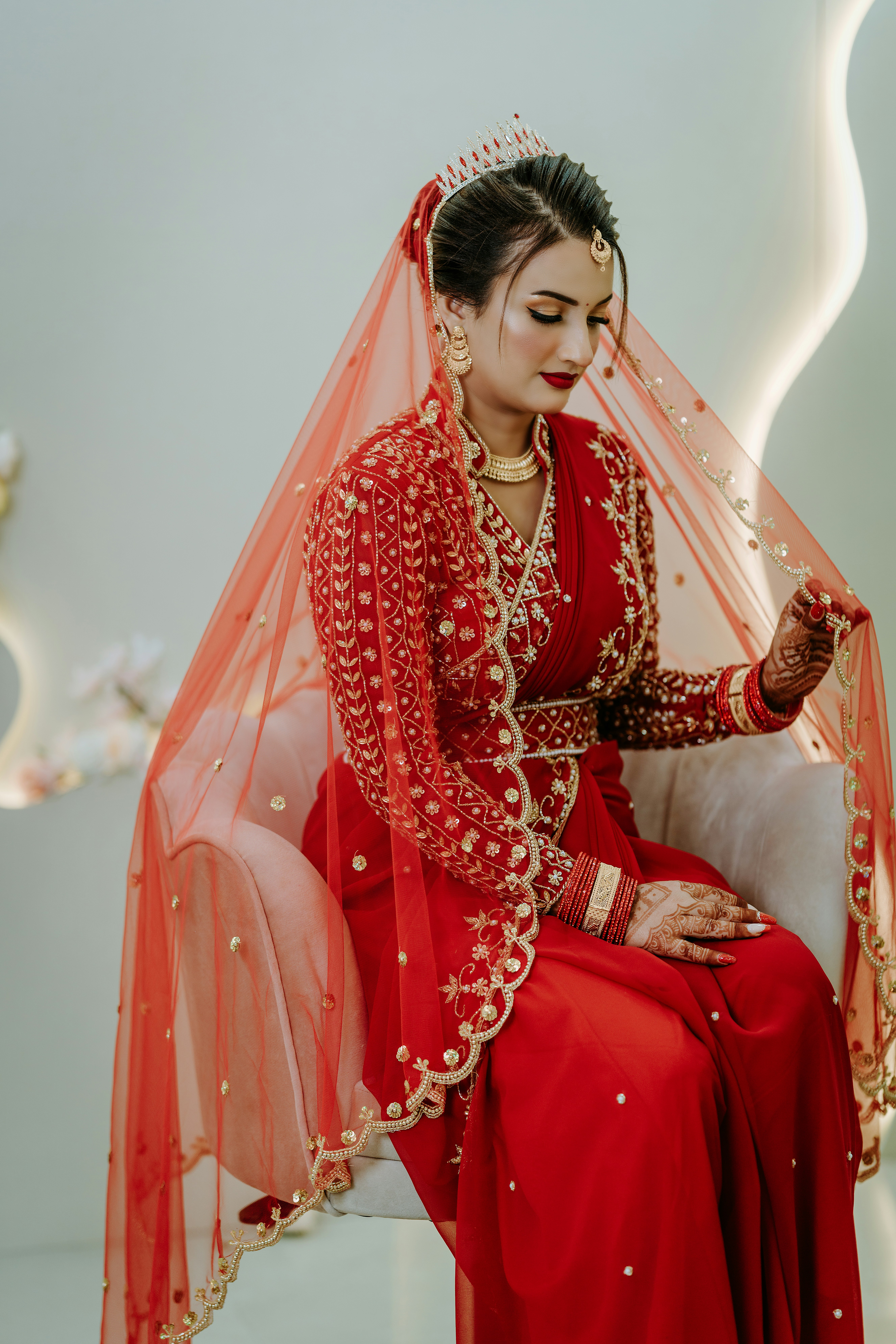 A woman in a red dress sitting down